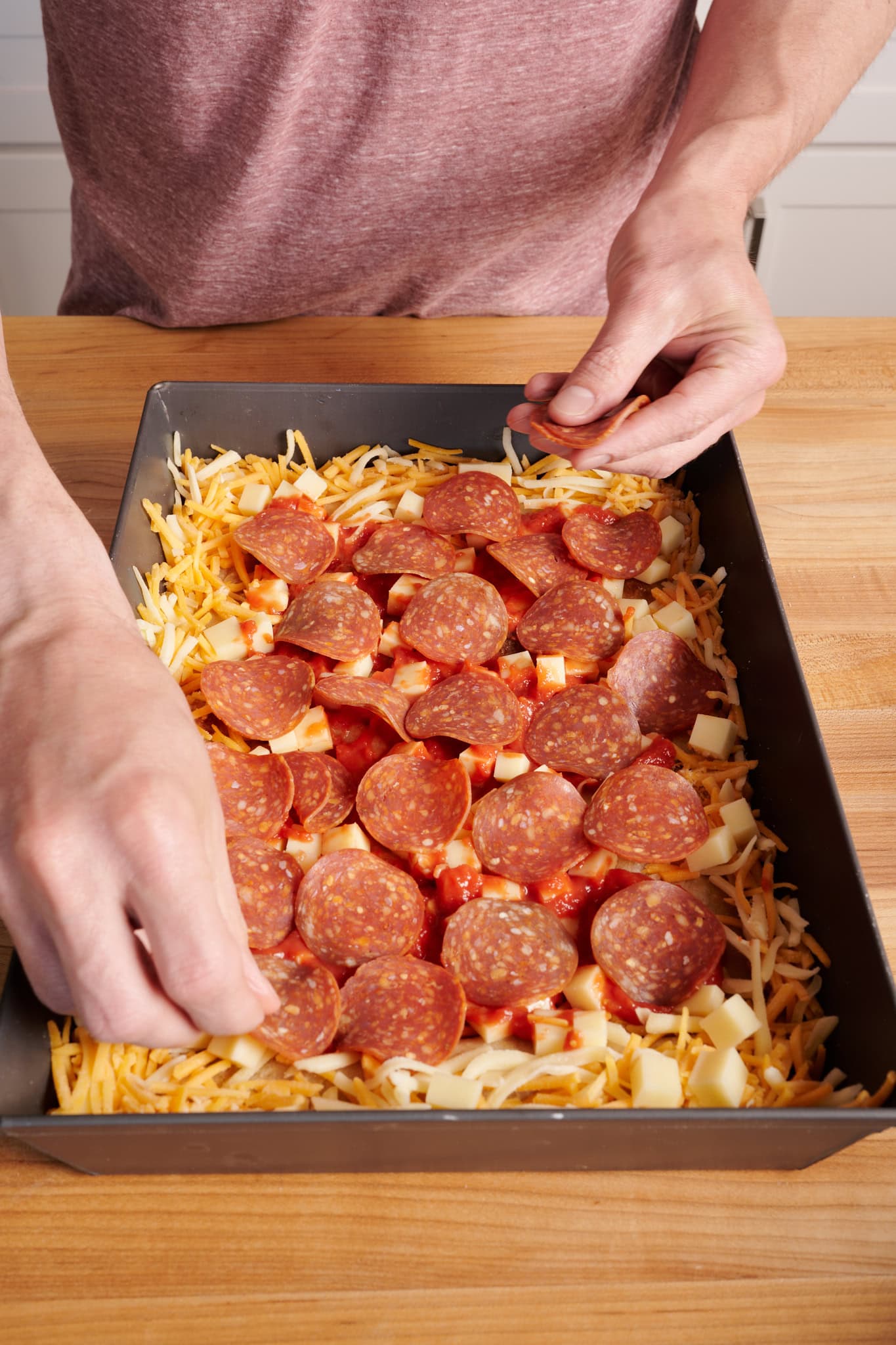 Spread the pepperoni evenly over the sauce.