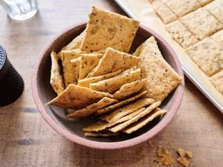 Seeded sourdough discard crackers in a bowl.